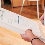 Person Holding White Printer Paper