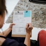 Woman Signing Documents